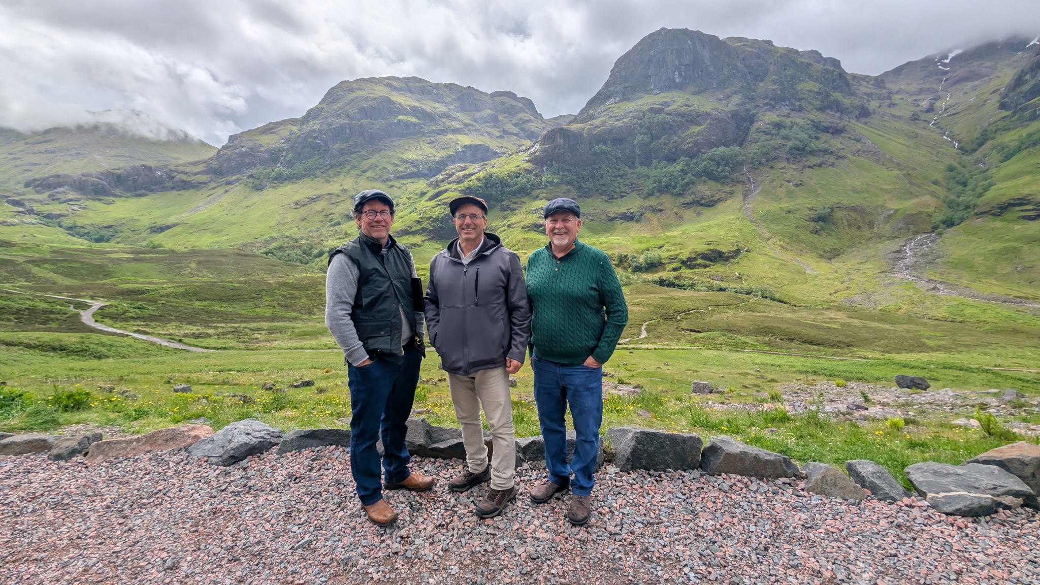 Travelers posing before the peaks of Glencoe