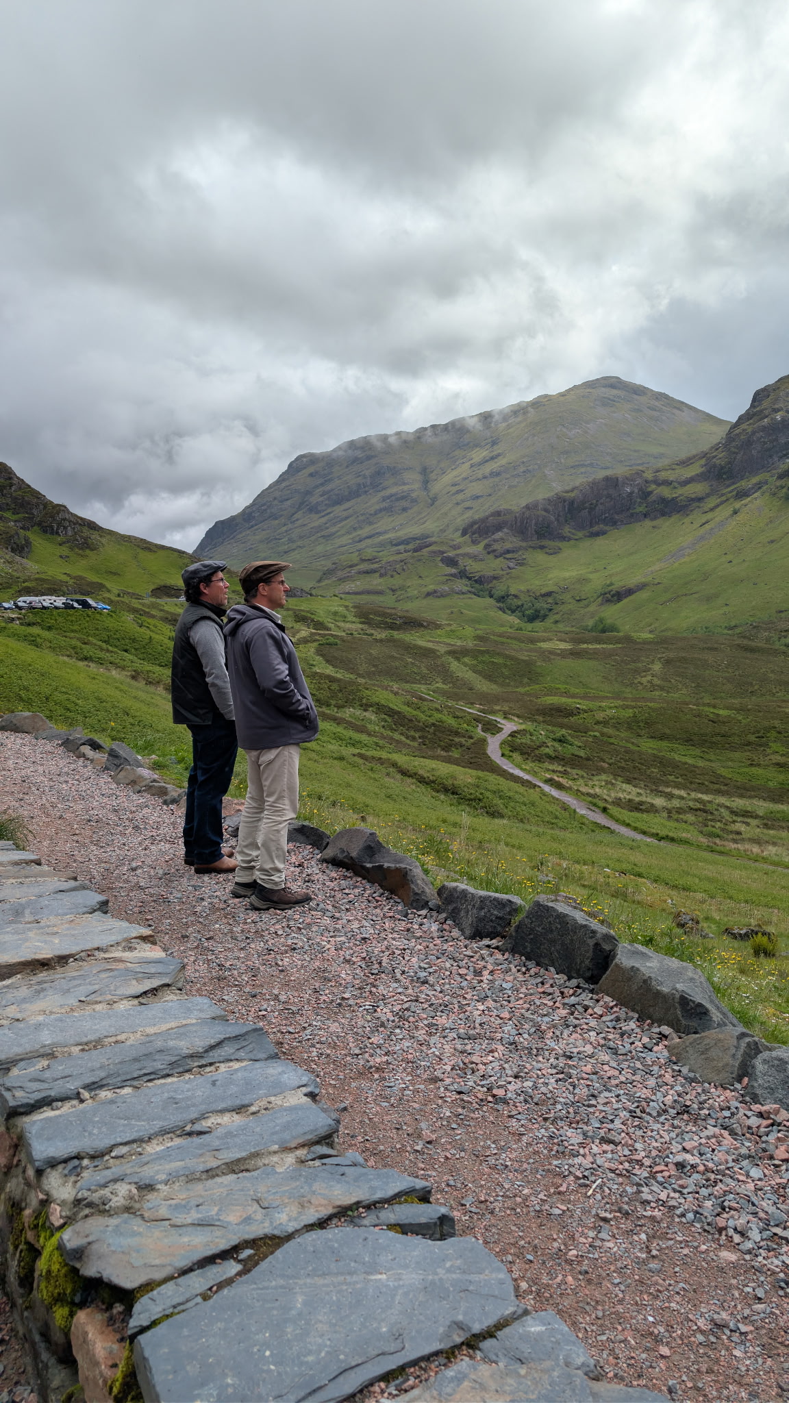 Travelers admiring the mountains of Glencoe
